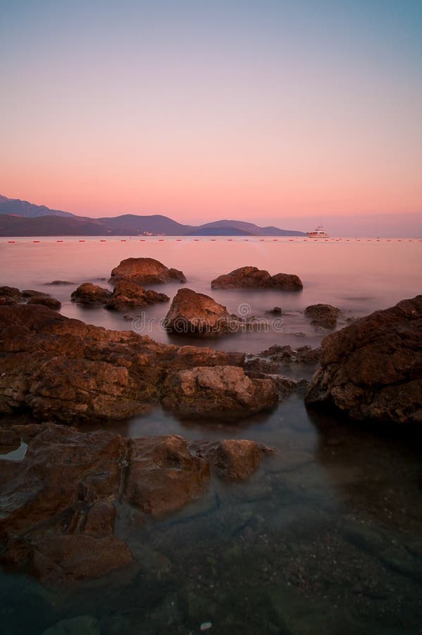 Sunset on rocky adriatic beach in Montenegro