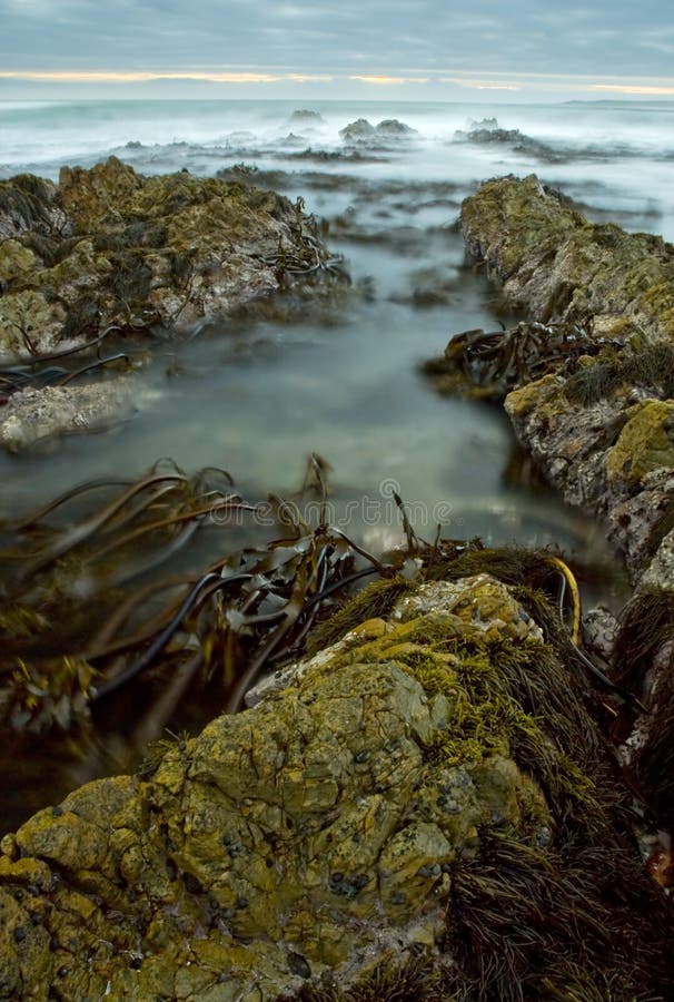 Sunset on rocky beach & water