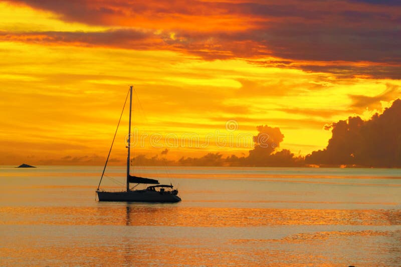 Sunset in sea and sailing yacht silhouette with beautiful landscape of Caribbean