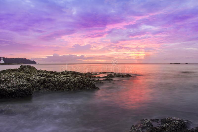 Sunset seascapes rock in water beach asia