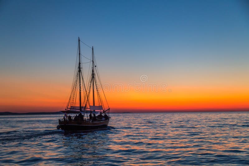 Sunset with silhouette of sailboat on the Adriatic sea near Zada