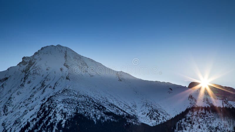 Sunset in a snowy alpine landscape.