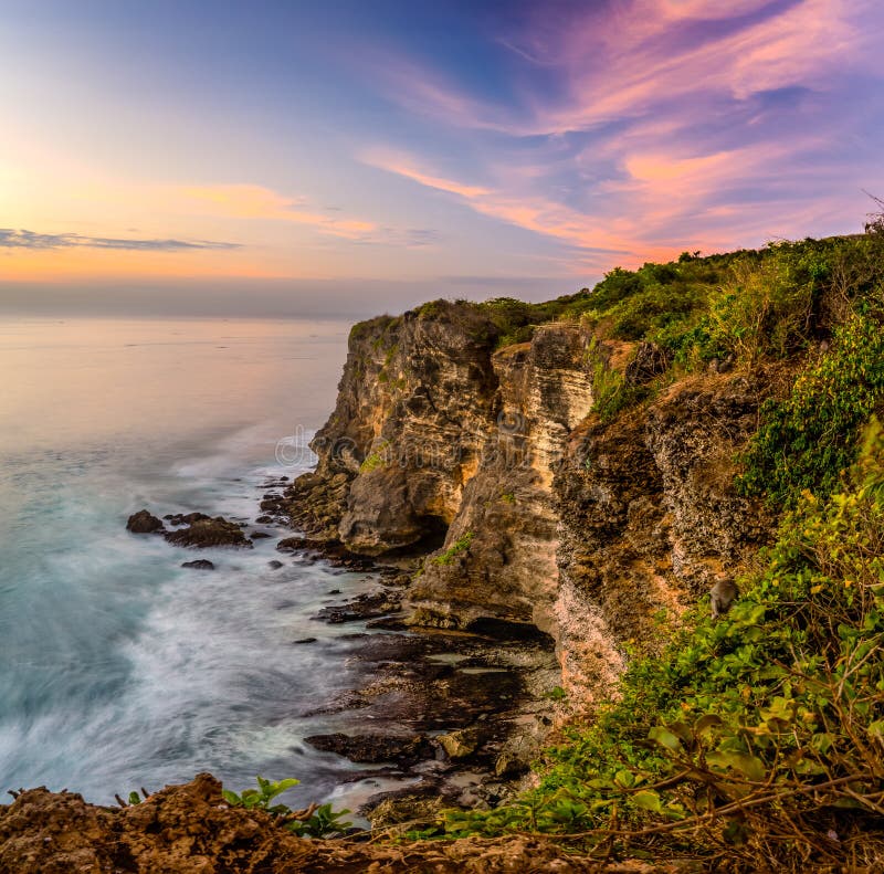 Sunset at Uluwatu cliff stock photo. Image of wave, rock - 46463350