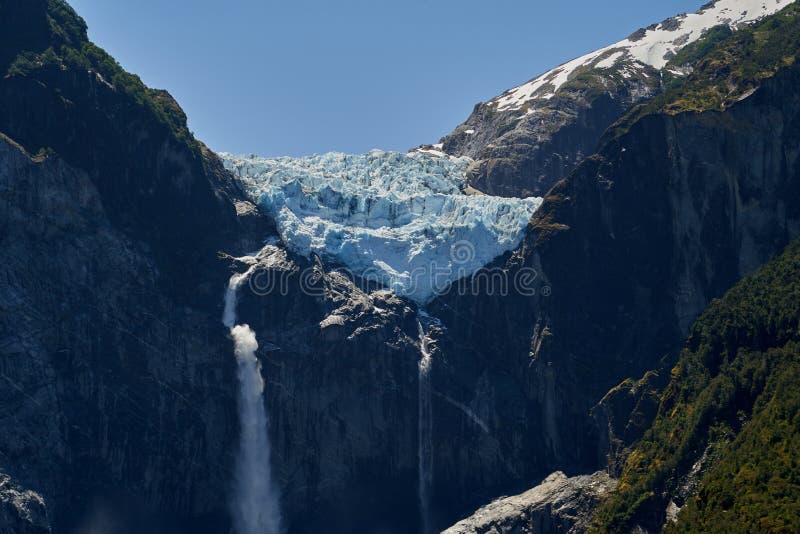 Sunset of Ventisquero Colgante, a hanging Glacier with waterfall and lake in queulat national park.