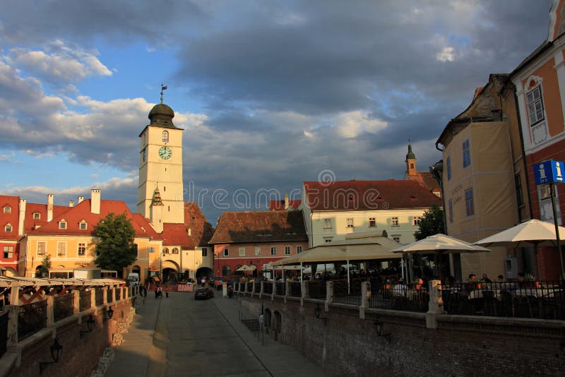 Tower of Council and Small Square in Sibiu under cloudy sky stock photo Tower of Council and Small Square in Sibiu under cloudy sky stock photo