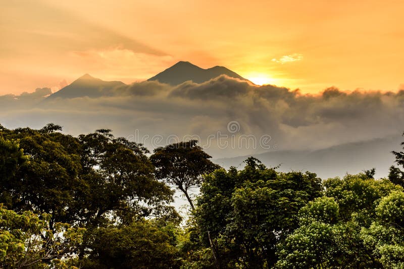 Fuego & Acatenango volcanoes at sunset outside Spanish colonial town & UNESCO World Heritage Site of Antigua in Panchoy Valley, Guatemala, Central America. Fuego & Acatenango volcanoes at sunset outside Spanish colonial town & UNESCO World Heritage Site of Antigua in Panchoy Valley, Guatemala, Central America