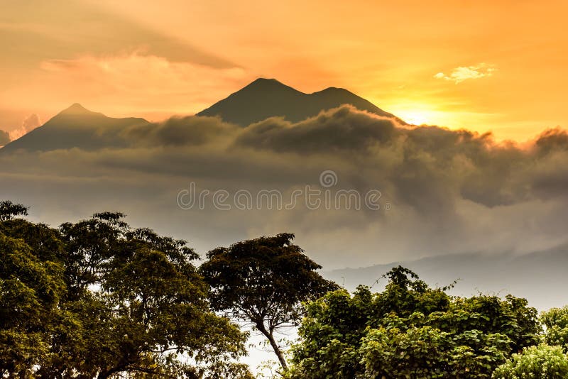 Fuego & Acatenango volcanoes at sunset outside Spanish colonial town & UNESCO World Heritage Site of Antigua in Panchoy Valley, Guatemala, Central America. Fuego & Acatenango volcanoes at sunset outside Spanish colonial town & UNESCO World Heritage Site of Antigua in Panchoy Valley, Guatemala, Central America