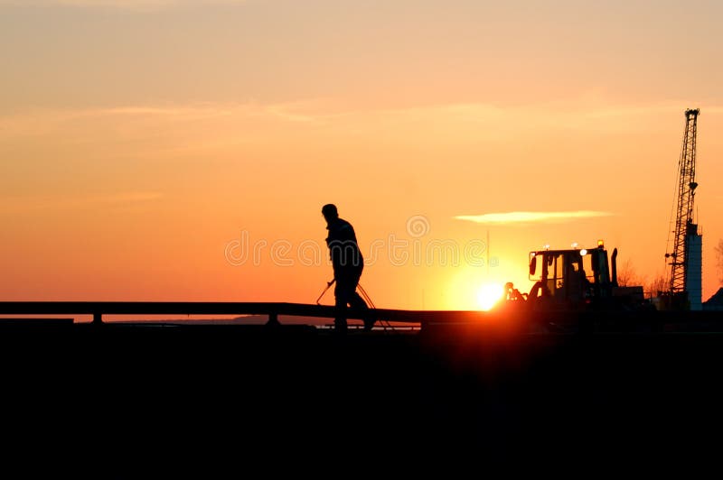 Silueta de soldador sobre el atardecer.