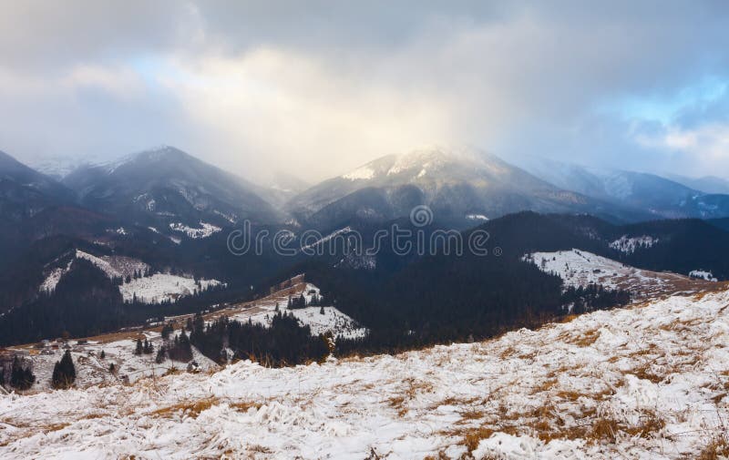 Sunset in winter mountains with dramatic light