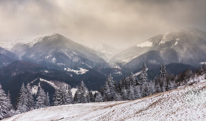 Sunset in winter mountains with dramatic light