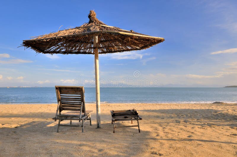 Sunshade and rest chair on sea sand