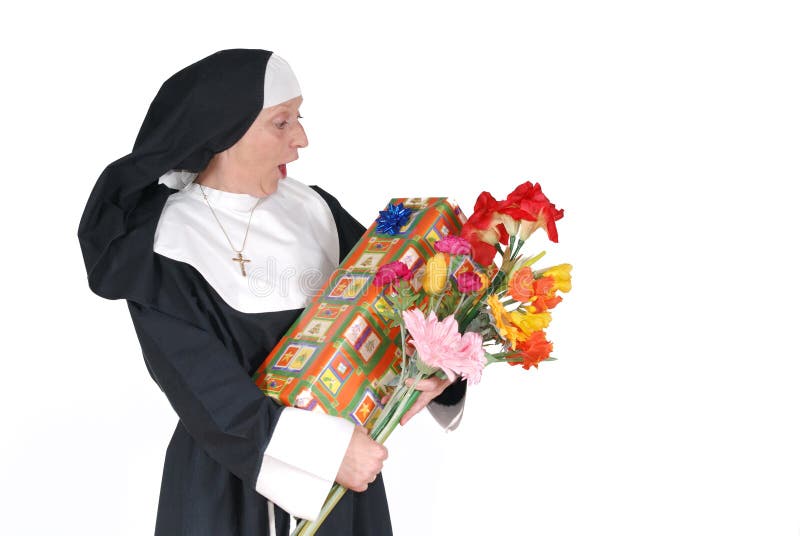 Middle aged sister, nun with birthday present and flowers, happy, surprised expression on face. Middle aged sister, nun with birthday present and flowers, happy, surprised expression on face