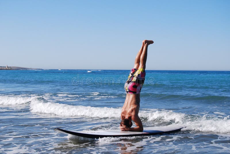 Man in headstand on SUP