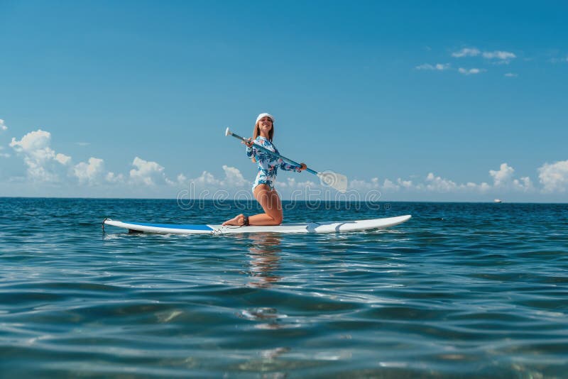 Woman Sup Sea. Happy Healthy Fit Woman in Bikini Relaxing on a Sup ...