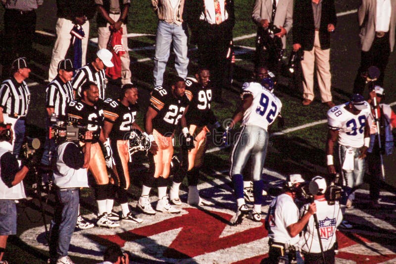 Members of the Pittsburgh Steelers and Tony Tolbert of the Dallas Cowboys (92) meet on the field before the start of Super Bowl XXX in Tempe, Arizona. (Image taken from color slide). Members of the Pittsburgh Steelers and Tony Tolbert of the Dallas Cowboys (92) meet on the field before the start of Super Bowl XXX in Tempe, Arizona. (Image taken from color slide)