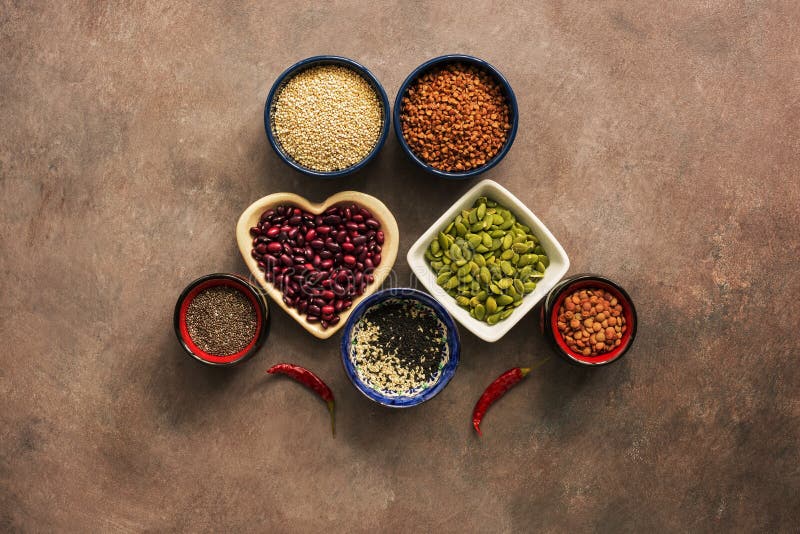 Super food cereals, legumes, seeds and chili peppers on a brown background. Chia, quinoa, beans, buckwheat, lentils, sesame, stock photos Super food cereals, legumes, seeds and chili peppers on a brown background. Chia, quinoa, beans, buckwheat, lentils, sesame, stock photos