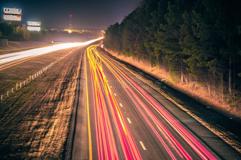 Super highway with high volume of cars at night. Charlotte, movement.