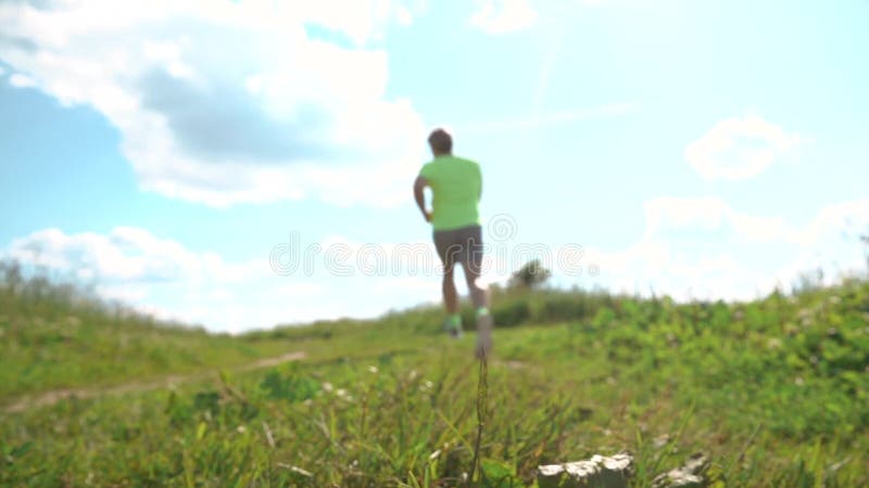 Defocused male athletic runner