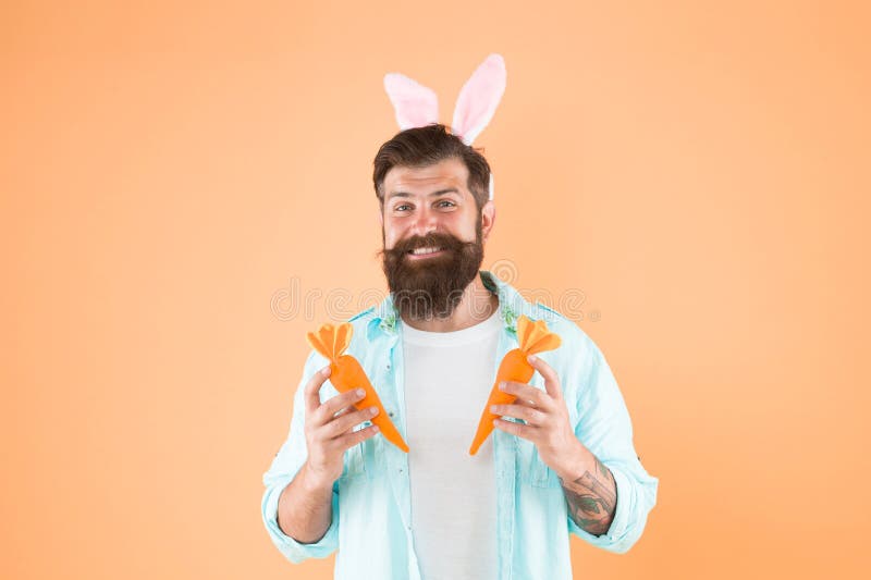 Super sweet yet healthy. Easter rabbit man hold carrots. Good health habits. Spring recipe for health. Healthy nutrition. Health benefits. Dieting for health. Easter fasting.
