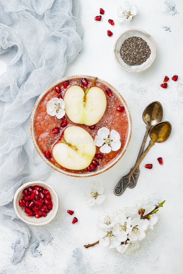 Superfoods smoothie bowl with chia seeds, pomegranate, sliced apples and honey. Overhead, flat lay. Rosh Hashana traditional food stock image Superfoods smoothie bowl with chia seeds, pomegranate, sliced apples and honey. Overhead, flat lay. Rosh Hashana traditional food stock image