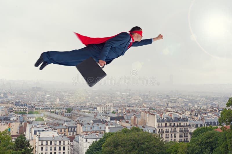 Superhero businessman flying above a city