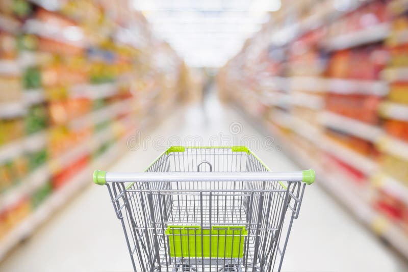 Supermarket aisle with empty shopping cart at grocery store