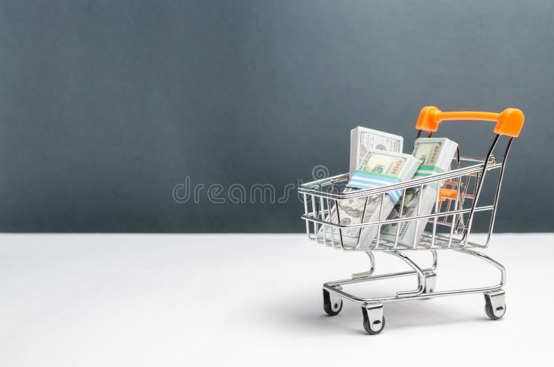 Supermarket cart with packs of dollars. The concept of microcredit and payday loans. Advertising financial services. Trap stock photography Supermarket cart with packs of dollars. The concept of microcredit and payday loans. Advertising financial services. Trap stock photography