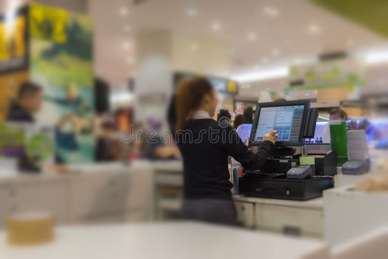 Cashier working in supermarket or department store. Cashier working in supermarket or department store