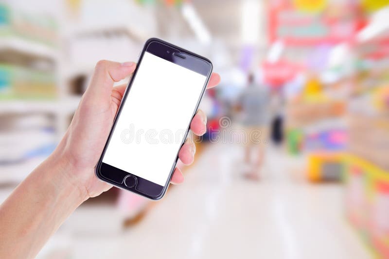 hand holding mobile smart phone on Supermarket blur background,Concept for sell shop on mobile phone. hand holding mobile smart phone on Supermarket blur background,Concept for sell shop on mobile phone