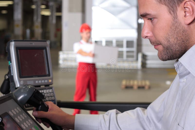 Supervisor at control panel in factory stock photo Supervisor at control panel in factory stock photo