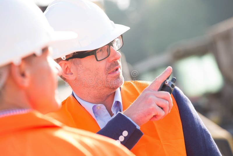 Supervisor que mostra algo ao colega no canteiro de obras imagens de stock royalty free Supervisor que mostra algo ao colega no canteiro de obras imagens de stock royalty free