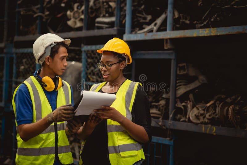 Supervisor staff black African women worker working with engineer male in factory industry royalty free stock images