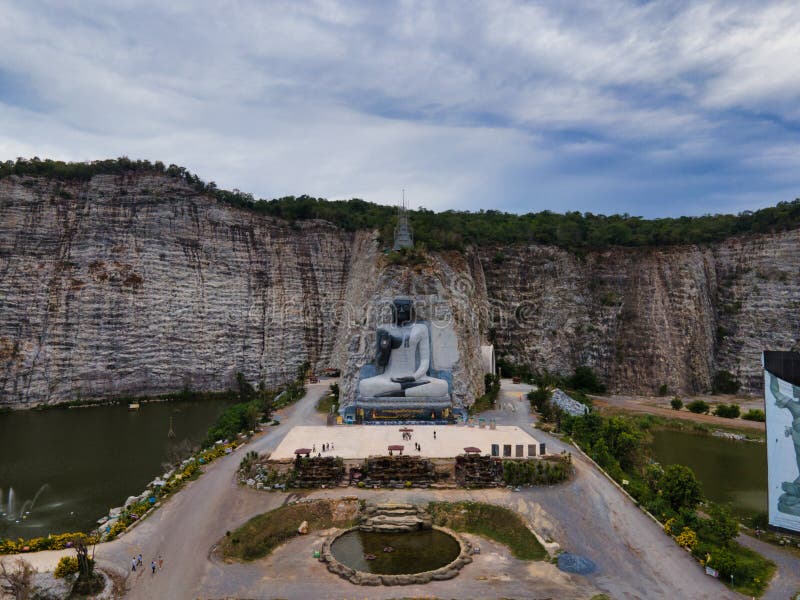 Suphan Buri / Thailand / August 15, 2020 :  Rock Buddha  Wat Khao Tham Thiam is the giant stone Buddha image in Suphanburi