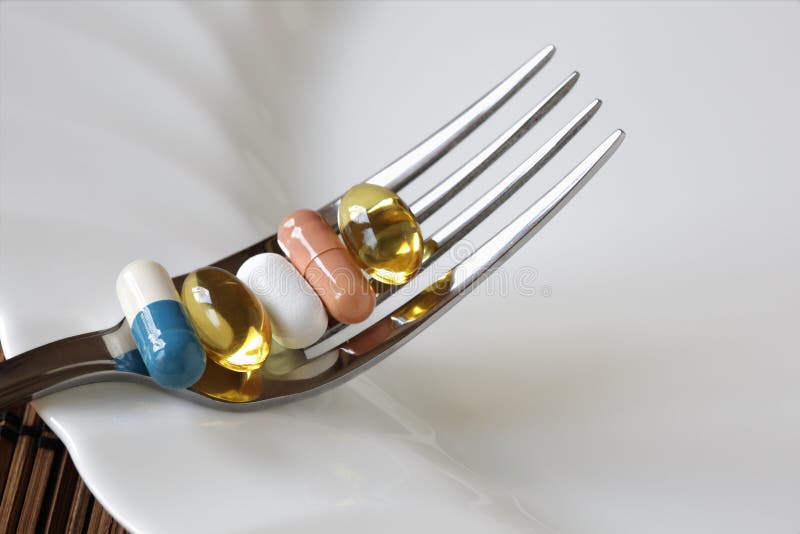 Medicine and nutritional supplement on a fork. Medicine and nutritional supplement on a fork