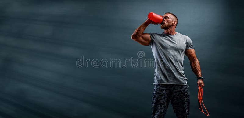 Nutritional Supplement. Muscular Men Drinks Protein, Energy Drink After Workout. studio shot. Nutritional Supplement. Muscular Men Drinks Protein, Energy Drink After Workout. studio shot