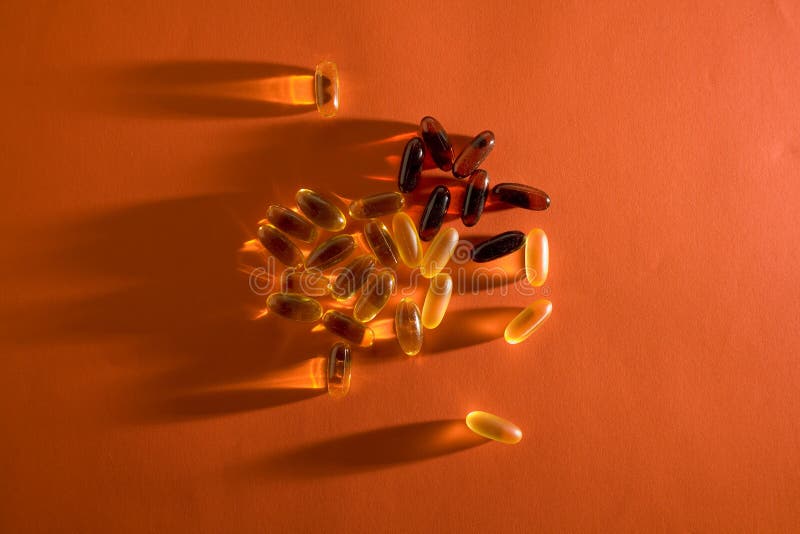 Multiple nutritional supplements on orange background. Multiple nutritional supplements on orange background