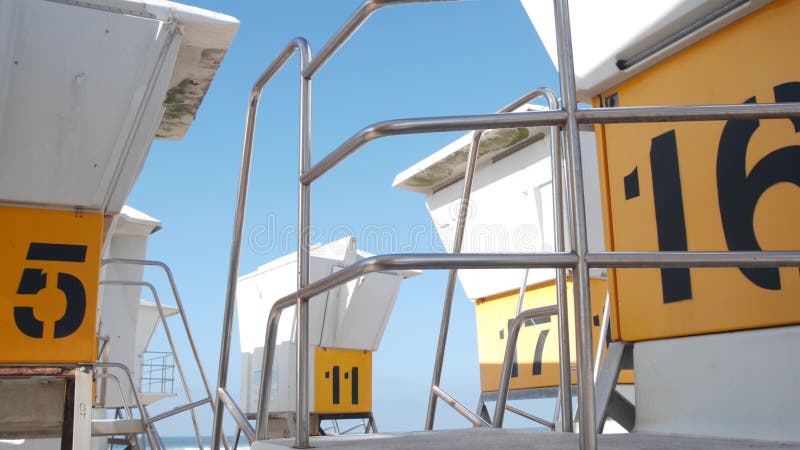 Lifeguard stand or life guard tower for surfing, California Mission beach, USA. Rescue hut, lifesaver station as surreal abstract vintage geometric background. Minimalism and modernism in architecture. Lifeguard stand or life guard tower for surfing, California Mission beach, USA. Rescue hut, lifesaver station as surreal abstract vintage geometric background. Minimalism and modernism in architecture