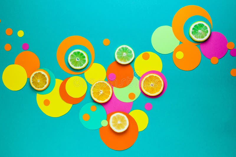 Suprematic colorful geometric shapes background with citrus fruits. Color blocking food and simple forms flat lay concept
