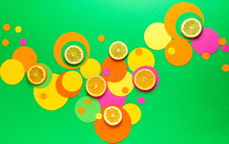 Suprematic colorful geometric shapes background with citrus fruits. Color blocking food and simple forms flat lay concept