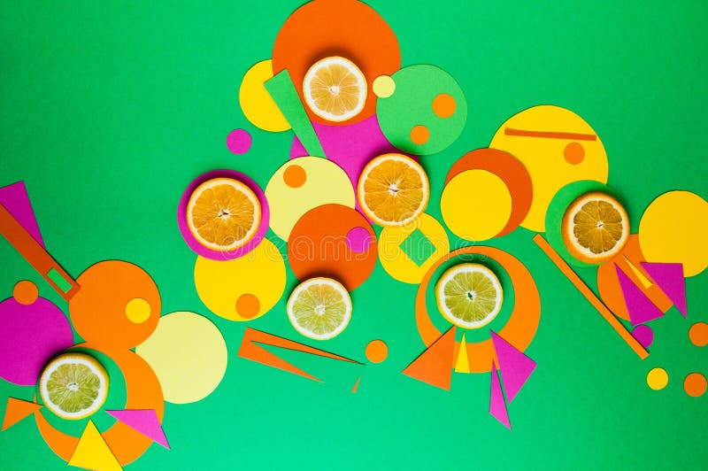 Suprematic colorful geometric shapes background with citrus fruits. Color blocking food and simple forms flat lay concept