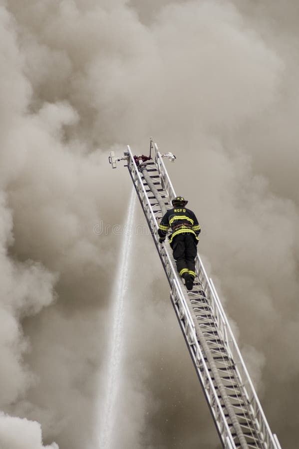 One fireman climbing to the top of the ladder. One fireman climbing to the top of the ladder.