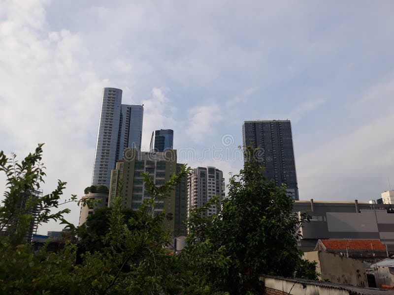 surabaya, Indonesia - September, 2022 : view of high rise buildings in the middle of the city from a cafe. Sheraton hotel and Tunjungan Plaza
