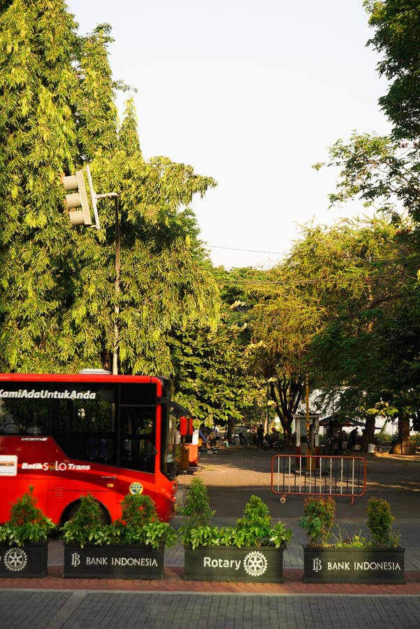 Surakarta, Indonesia - October 3, 2021: Buses and public transportation in the city of Solo Raya named Batik Solo Trans BST operating in Surakarta which are picking up passengers at a bus stop. Surakarta, Indonesia - October 3, 2021: Buses and public transportation in the city of Solo Raya named Batik Solo Trans BST operating in Surakarta which are picking up passengers at a bus stop