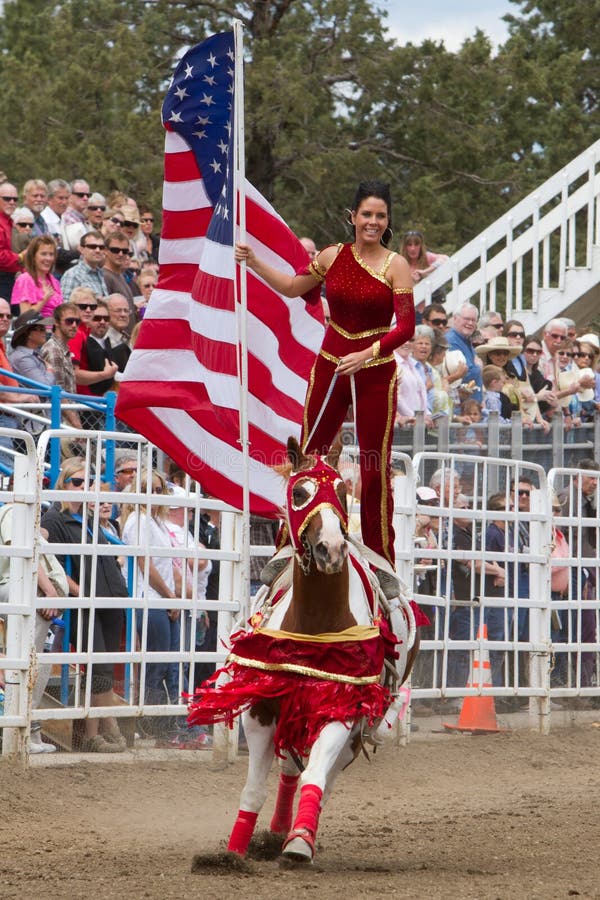 A rider from the Sure Shot Acts displays the American Flag during the playing of the National Anthem Before the 2011 PRCA Rodeo in Sisters, Oregon. A rider from the Sure Shot Acts displays the American Flag during the playing of the National Anthem Before the 2011 PRCA Rodeo in Sisters, Oregon.