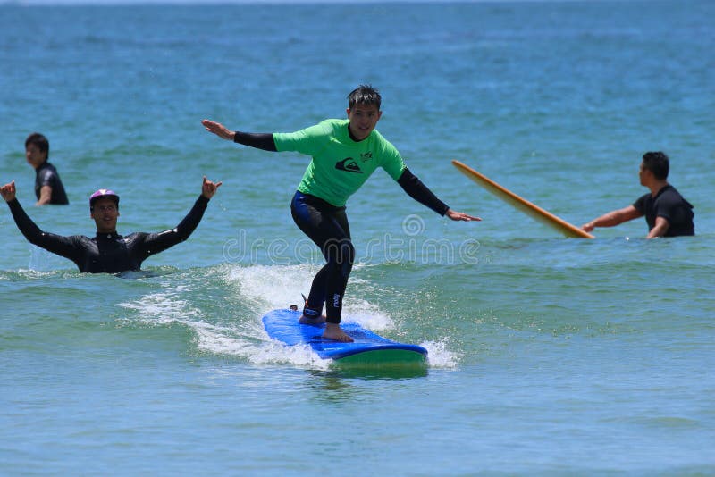Surf school, a group of people are learning to surf in Chiba close to Ichinomiya.