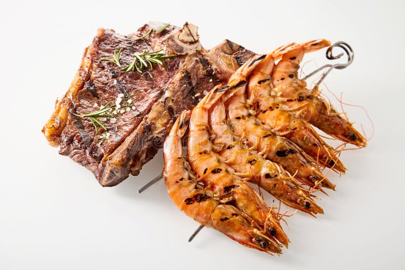 Surf and turf T-bone steak and prawns stock photos Surf and turf T-bone steak and prawns stock photos