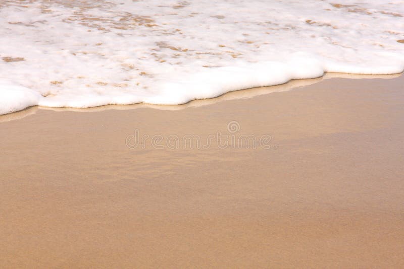 Surf washing up on the beach royalty free stock images