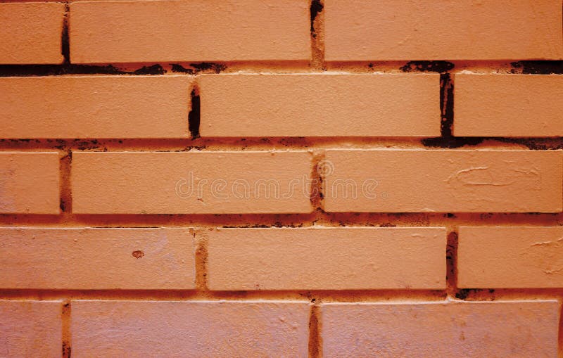 The Surface of a Brick Wall Painted with Yellow Paint. Stock Image