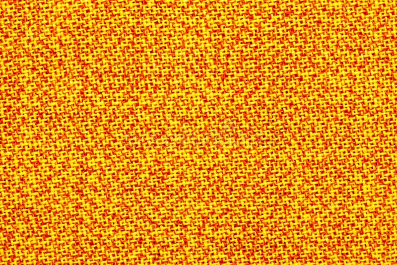 Surface of the fabric is yellow and orange. Bright, colorful background, texture