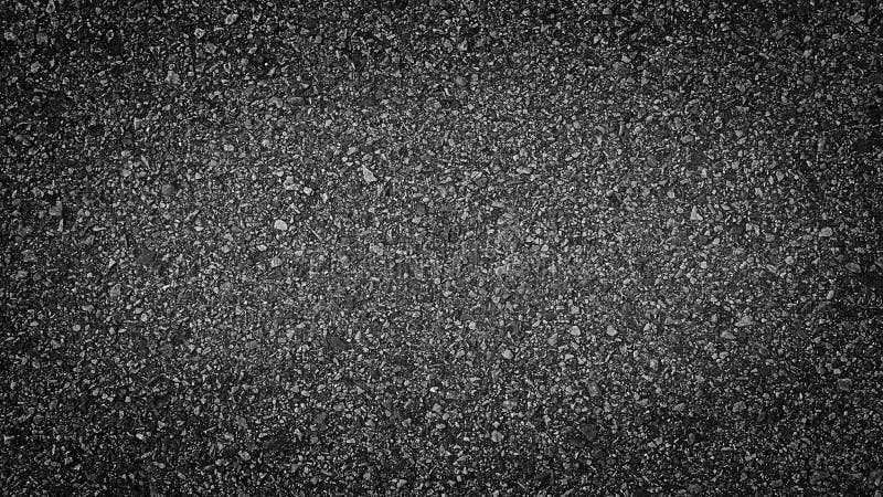 Surface grunge rough of asphalt  Grey grainy road lit in the center and shadows edges  Texture background with vignette  Top view.